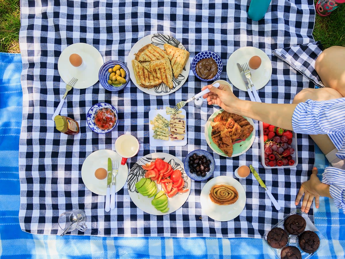 A spread to impress: there’s no better time to pack a picnic and enjoy the great outdoors (Getty)