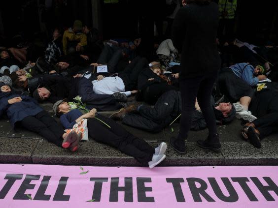 Members of Extinction Rebellion lay down on the floor as they protest outside Northcliffe House which contains the offices of the Daily Mail, Evening Standard and the Independent newspapers (Reuters)