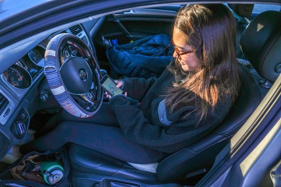 Reporter Antonia Noori Farzan checks her navigation system before racing to downtown Providence.