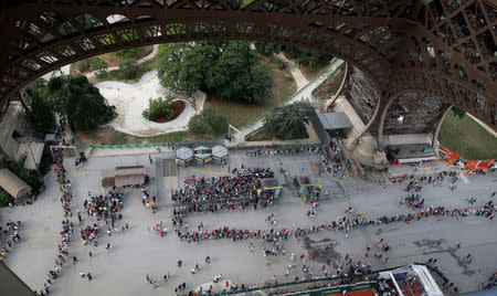 FILE PHOTO: Visitors queue to visit the Eiffel tower in Paris, France, June 2, 2018. REUTERS/Philippe Wojazer/File Photo