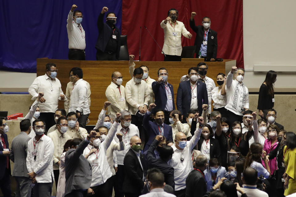 Supporters of new house speaker Lord Allan Velasco gestures after posing for pictures at the House of Representatives in Quezon city, Philippines on Tuesday, Oct. 13, 2020. A large faction of Philippine legislators in the House of Representatives elected a new leader Monday in a tense political standoff between two allies of the president. (AP Photo/Aaron Favila)