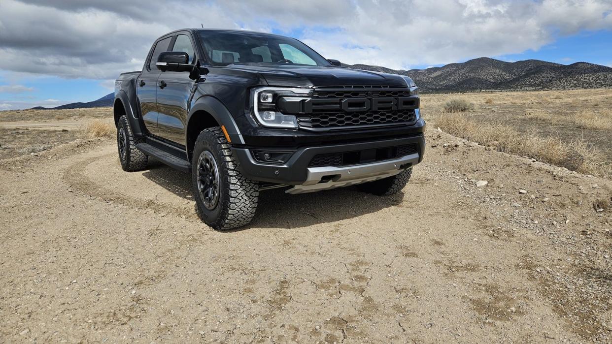 a black car parked on a dirt road