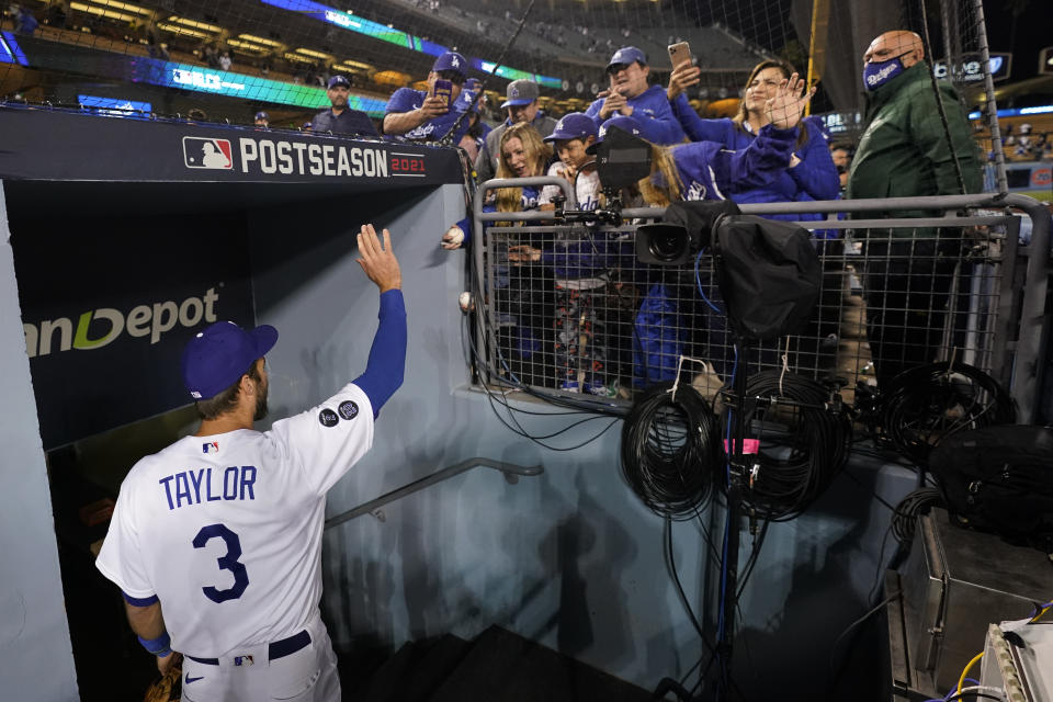 Los Angeles Dodgers left fielder Chris Taylor waves to fans after Game 5 of baseball's National League Championship Series against the Atlanta Braves Thursday, Oct. 21, 2021, in Los Angeles. The Dodgers defeated the Braves 11-2. The Braves lead the series 3-2 games. (AP Photo/Jae C. Hong)