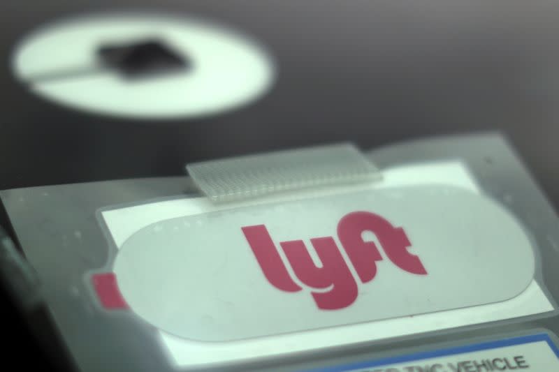FILE PHOTO: Uber and Lyft stickers are seen on a car windscreen as protesters join an Uber drivers' strike for higher wages at LAX airport in Los Angeles