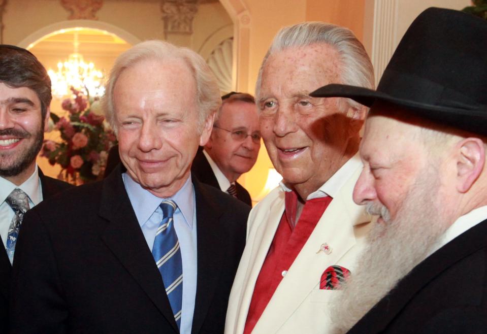 031410 (Bruce R. Bennett/The Palm Beach Post) PALM BEACH -- Senator Joe Lieberman arrives at the home of Norma and Simon Fireman Sunday evening for a Rabbinical College of America Founders' Event. Here, Lieberman (center left) poses for photos with Fireman (center right). For Scott Eyman story. SCR 2655