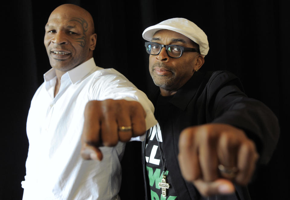 Spike Lee, right, director of "Mike Tyson: Undisputed Truth," poses with Tyson backstage during HBO's Summer 2013 TCA panel at the Beverly Hilton Hotel on Thursday, July 25, 2013, in Beverly Hills, Calif. The former heavyweight champion teamed with Lee to bring Tyson’s one-man stage show to HBO later this year. The program was filmed on Broadway, where ``Mike Tyson: Undisputed Truth’’ ran last summer. (Photo by Chris Pizzello/Invision/AP)