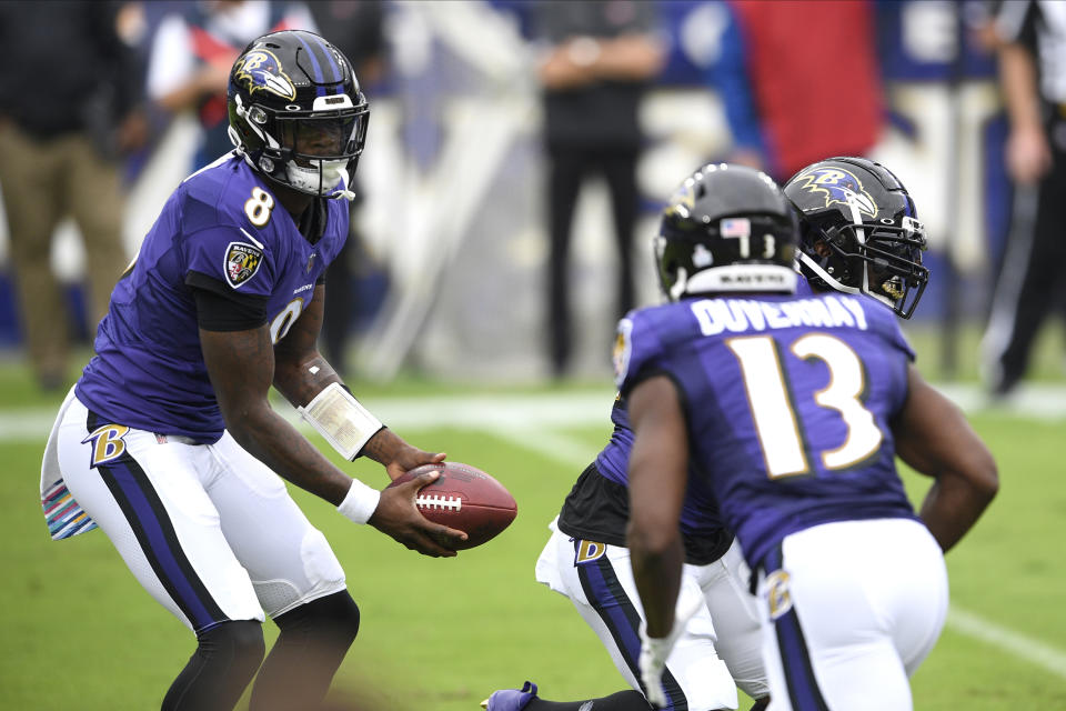 Baltimore Ravens quarterback Lamar Jackson isn't running as much in 2020. (AP Photo/Nick Wass)