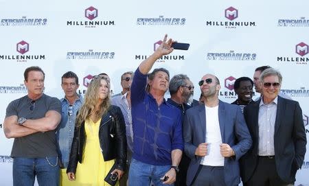 (L-R) Cast members Arnold Schwarzenegger, Antonio Banderas, Ronda Rousey, Sylvester Stallone, Mel Gibson, Jason Statham, Wesley Snipes and Harrison Ford pose during a photocall on the Croisette to promote the film "The Expendables 3" during the 67th Cannes Film Festival in Cannes May 18, 2014. REUTERS/Yves Herman