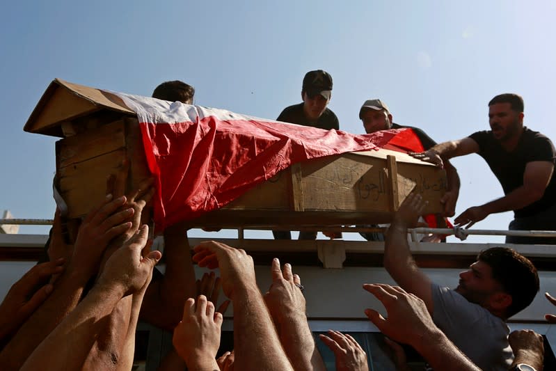 Mourners carry the coffin of a demonstrator who was killed at anti-government protests, during a funeral in Najaf