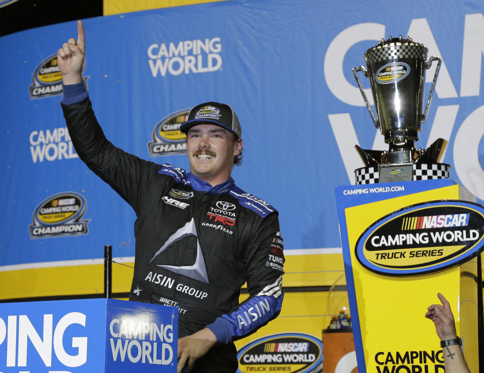 Brett Moffitt celebrates in Victory Lane after winning the NASCAR Truck Series season title at Homestead-Miami Speedway in Homestead, Fla., Friday, Nov. 16, 2018. (AP Photo/Terry Renna)