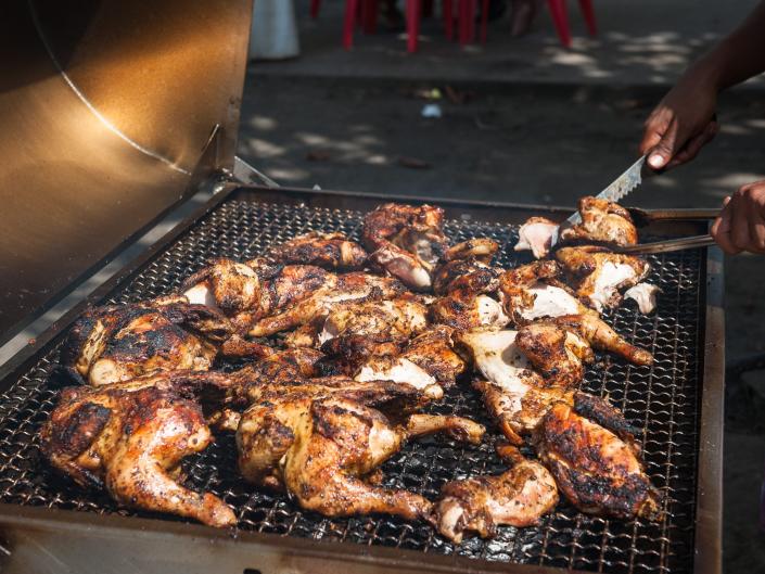 Barbecue chicken being cooked by the beach in the seaside village of, Le Diamant, Martinique