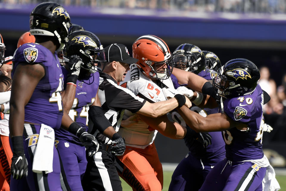 Cleveland Browns center JC Tretter (64) scuffles with Baltimore Ravens inside linebacker Kenny Young (40) during the second half of an NFL football game Sunday, Sept. 29, 2019, in Baltimore. (AP Photo/Brien Aho)