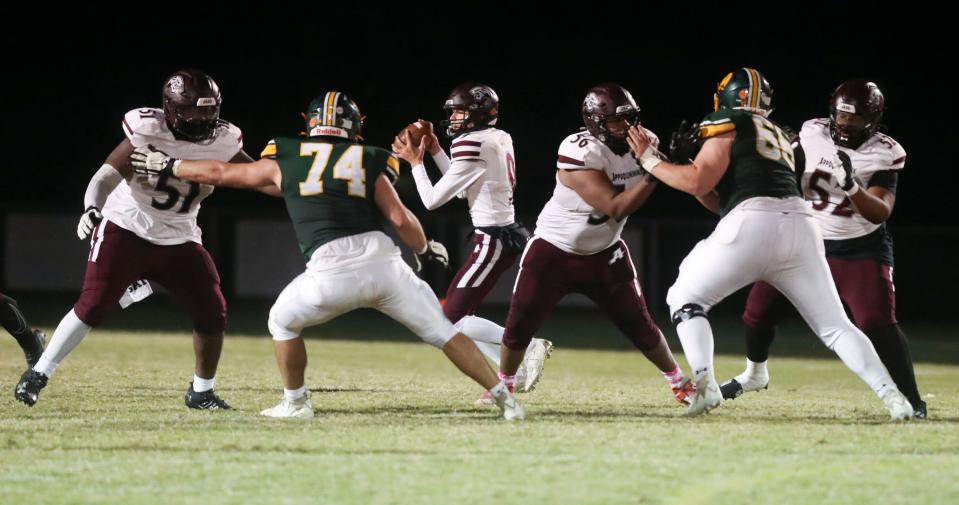 Appoquinimink quarterback Blake Caccamo throws behind protection from (from left) Renard Dugue, Jaren Polk and Miko Gibson in the third quarter of the Jaguars' 40-15 win at Saint Mark's, Friday, Oct. 13. 2023.