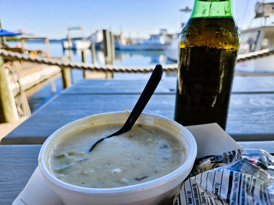 A bowl of warm stone crab chowder and a cold bottle of Yuengling Traditional Lager on the docks at Star Fish Company restaurant in Cortez photographed Oct. 17, 2023.