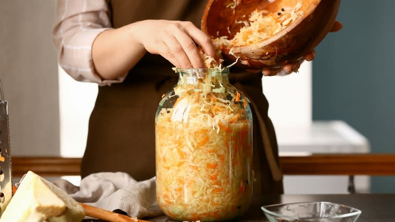 sauerkraut being packed into jar