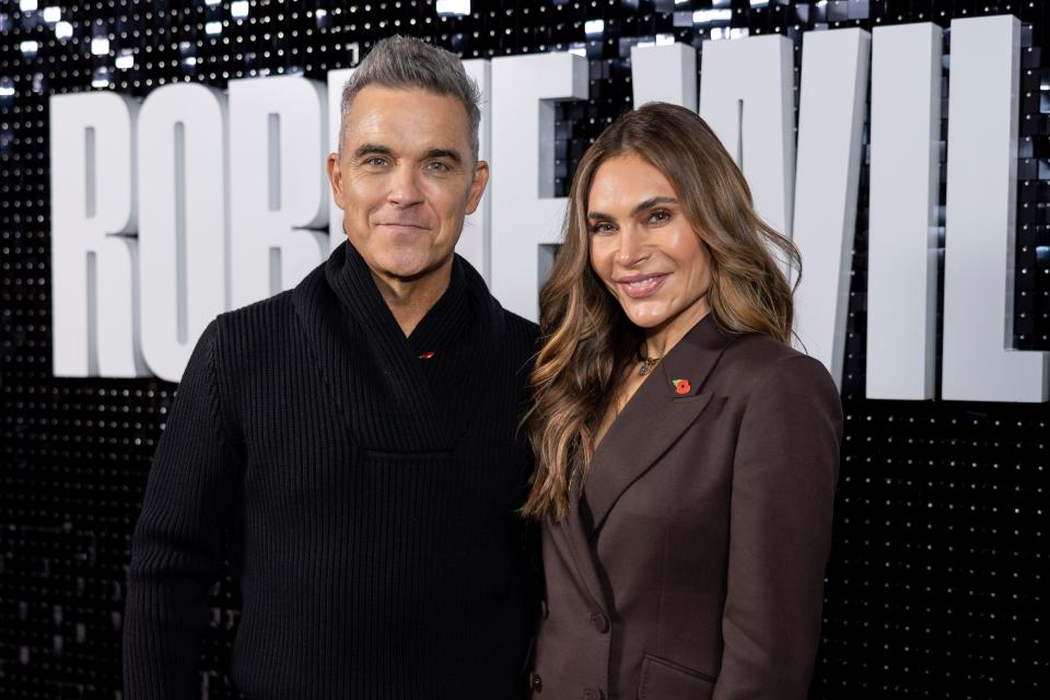 Robbie Williams, left, and Ayda Field pose for photographers upon arrival at the premiere for the Robbie Williams documentary on Wednesday, Nov. 1, 2023 in London. (Vianney Le Caer/Invision/AP)