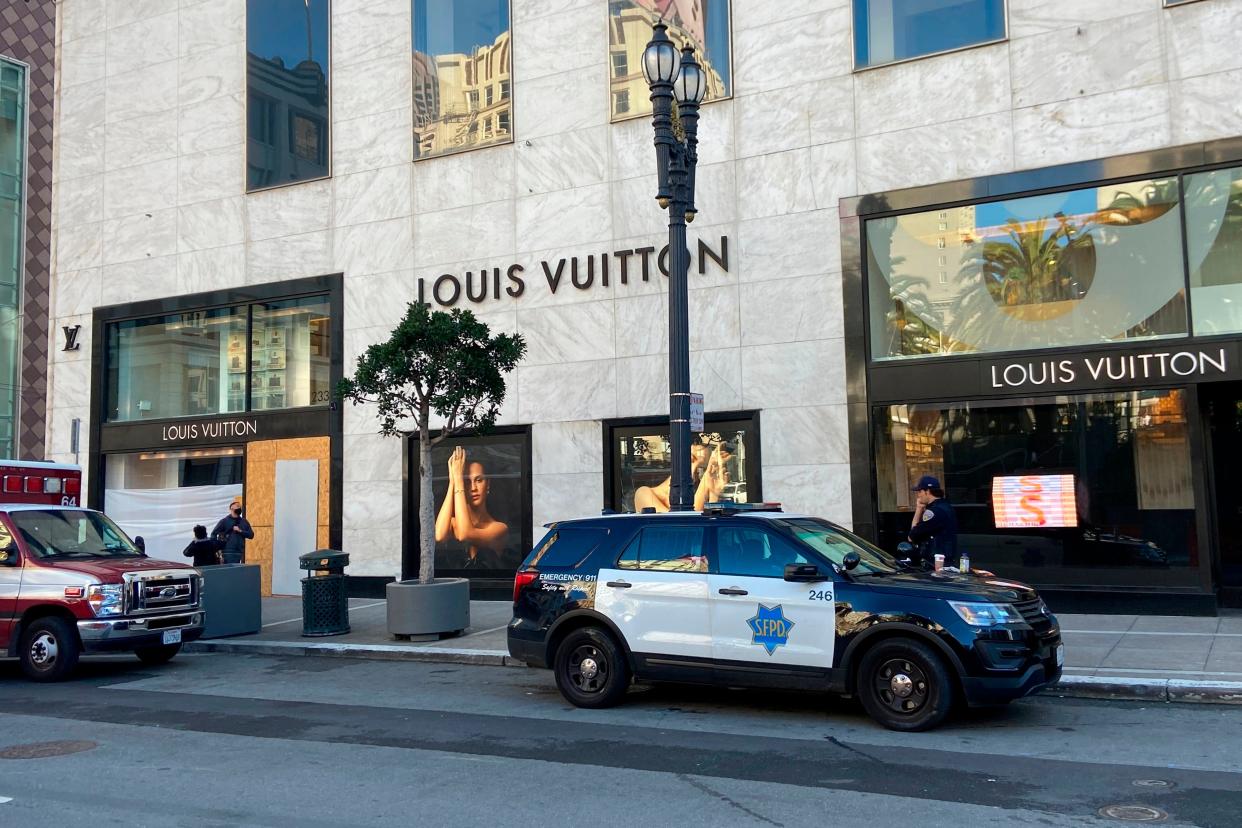 FILE - Police officers and emergency crews park outside the Louis Vuitton store in San Francisco's Union Square on Nov. 21, 2021, after looters ransacked businesses. Stung by recent headline-grabbing smash-and-grab robberies at high-end stores, California Gov. Gavin Newsom said Friday, Dec. 17, 2021, that he will seek more than $300 million over three years to boost law enforcement efforts on retail theft, while he also is targeting increasing gun violence. (Danielle Echeverria/San Francisco Chronicle via AP, File)