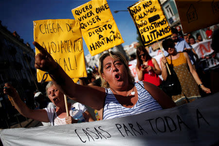 People shout slogans during a demonstration against evictions and rising of rent prices in central Lisbon, Portugal September 22, 2018. REUTERS/Pedro Nunes