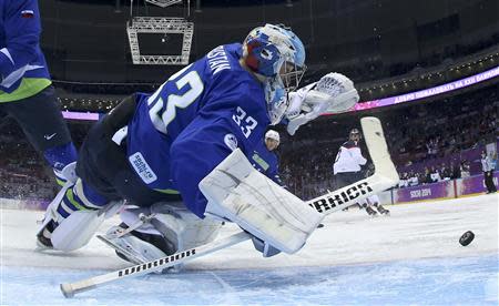 Slovenia's goalie Robert Kristan makes a save on Slovakia during the first period of their men's preliminary round ice hockey game at the 2014 Sochi Winter Olympic Games, February 15, 2014. REUTERS/Bruce Bennett/Pool