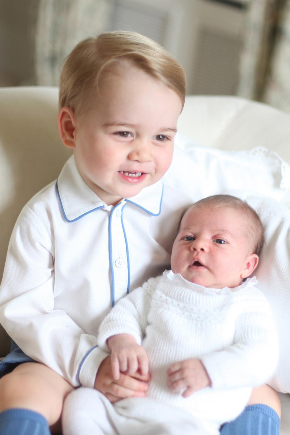 <p>How sweet is this picture of an almost two-year-old Prince George with his baby sister Charlotte? [Photo: PA Images] </p>