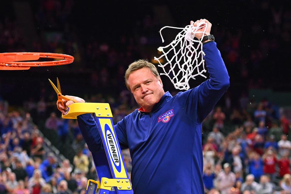 Bill Self celebrates after cutting down the net in April.