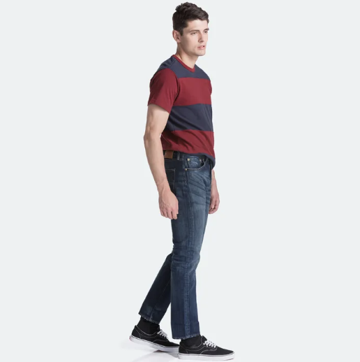 man wearing dark blue jeans and red striped top