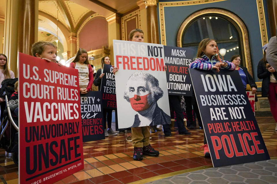 Protestors gather in the Iowa Capitol rotunda to voice their opposition to mask mandates, Monday, Jan. 11, 2021, at the Statehouse in Des Moines, Iowa. (AP Photo/Charlie Neibergall)