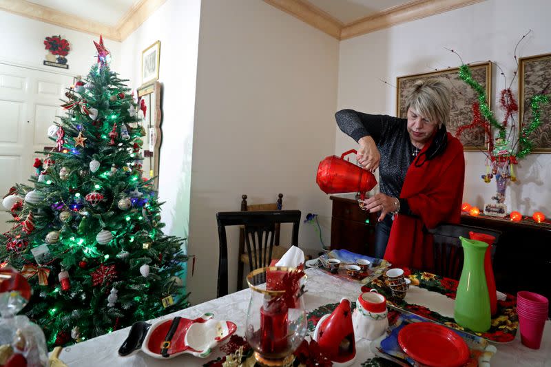 Palestinian Christian woman Ghada Abu Daoud pours a cup of coffee as she decorates her house ahead of Christmas in Gaza City