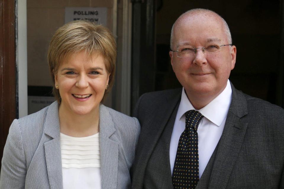 Peter Murrell, pictured with his wife Nicola Sturgeon, has been charged in an investigation into the SNP’s finances (PA)