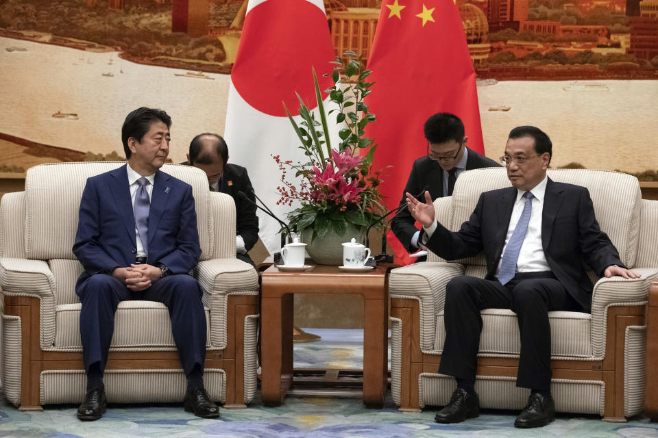 Chinese Premier Li Keqiang, right, and Japanese Prime Minister Shinzo Abe meet at the Great Hall of the People in Beijing, Thursday, Oct. 25, 2018. Abe arrived in Beijing on Thursday as both countries try to repair ties that have been riven by disputes over territory, military expansion in the Pacific and World War II history. (Roman Pilipey/Pool Photo via AP)