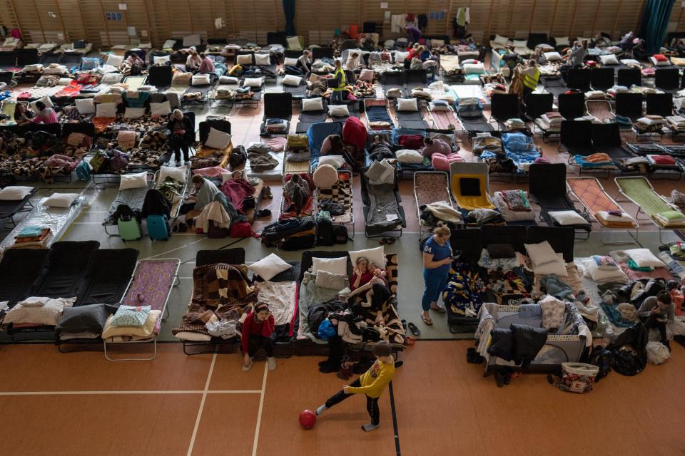 Bedspaces laid out in a sports hall in Poland (Petros Giannakouris/AP)