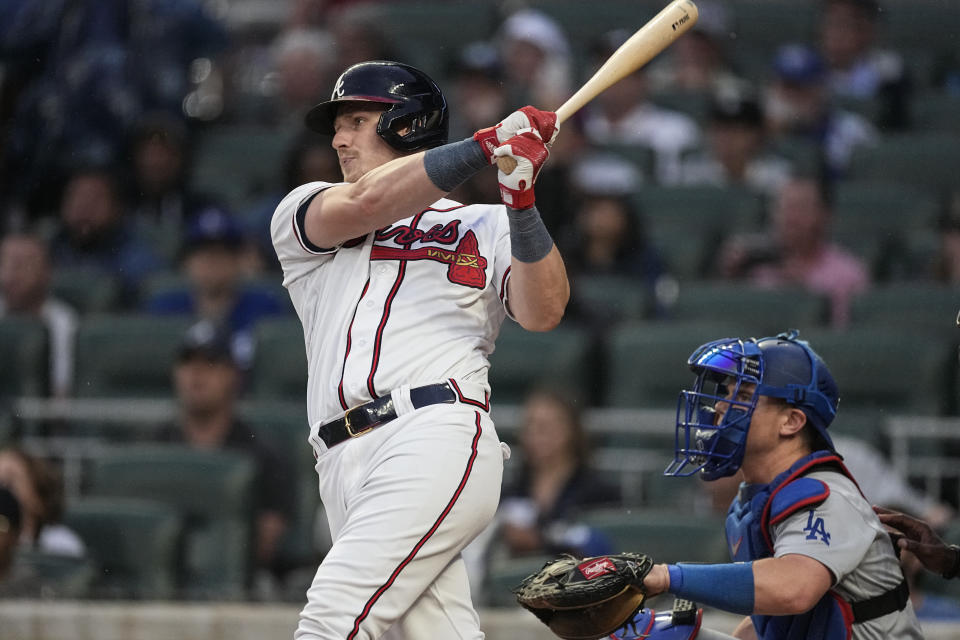 Atlanta Braves' Sean Murphy drives in a run with a base hit as Los Angeles Dodgers catcher Will Smith looks on in the first inning of a baseball game, Monday, May 22, 2023, in Atlanta. (AP Photo/John Bazemore)