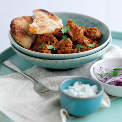 Mutton curry in blue bowl with onion