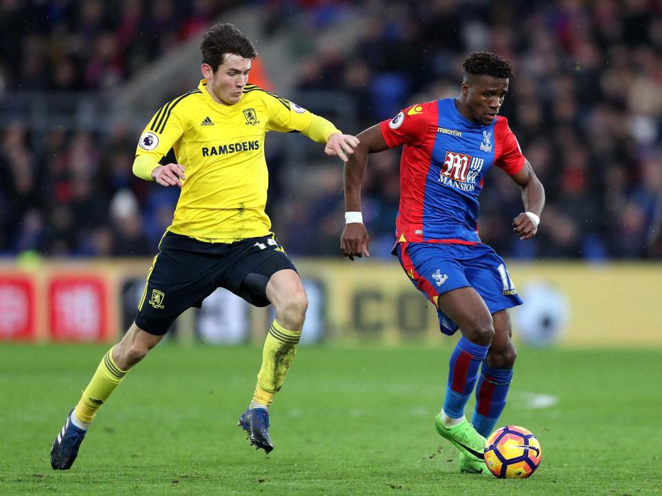 Wilfried Zaha bids to get away from Marten de Roon (Getty)