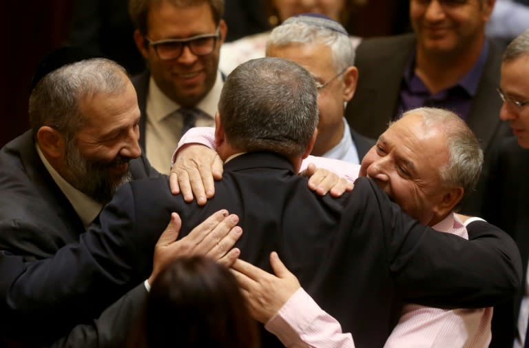 Newly-appointed Israeli Defence Minister Avigdor Lieberman (C), the head of hardline nationalist party Yisrael Beitenu, is congratulated by MPs after he was sworn in during a Knesset session on May 30, 2016, in Jerusalem