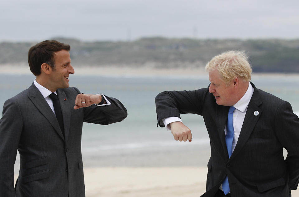 British Prime Minister Boris Johnson, right, greets French President Emmanuel Macron during arrivals for the G7 meeting at the Carbis Bay Hotel in Carbis Bay, St. Ives, Cornwall, England, Friday, June 11, 2021. Leaders of the G7 begin their first of three days of meetings on Friday, in which they will discuss COVID-19, climate, foreign policy and the economy. (Phil Noble, Pool via AP)