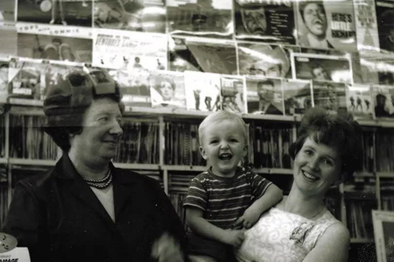 The Musical Box Record Shop on West Derby Road in Tuebrook is about to reach a milestone birthday. Thought to be the oldest surviving record store in Liverpool, it's run by owners Tony Quinn and his wife Paula. Pictured, Tony Quinn's nan Diane Cain (shop's original owner) next to two-year-old Tony in the arms of his mum, Diane.