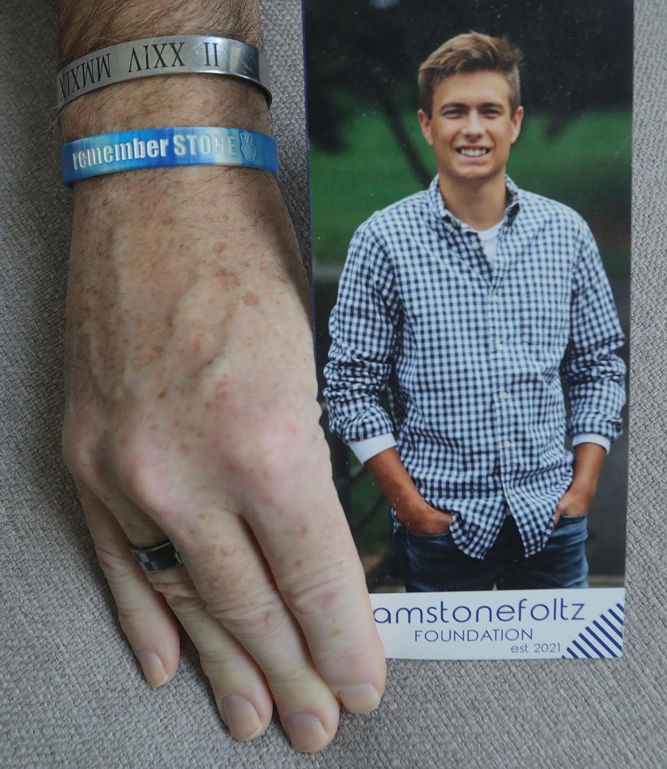 Liver recipient Scott Herold wears a wrist band that reads "remember Stone" this month in Wadsworth.