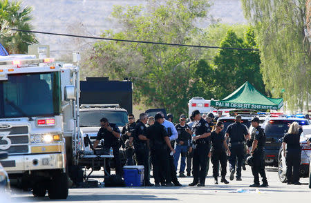 Police officers from various agencies are shown at their command center during a standoff where three officers were shot by a suspect in Palm Springs, California, U.S. October 8, 2016. REUTERS/Sam Mircovich