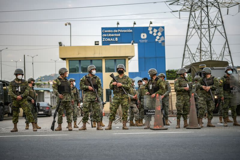 Soldier stand guard outside a prison where inmates were killed during a riot that the government described as a concerted action by criminal organisations, in Guayaquil