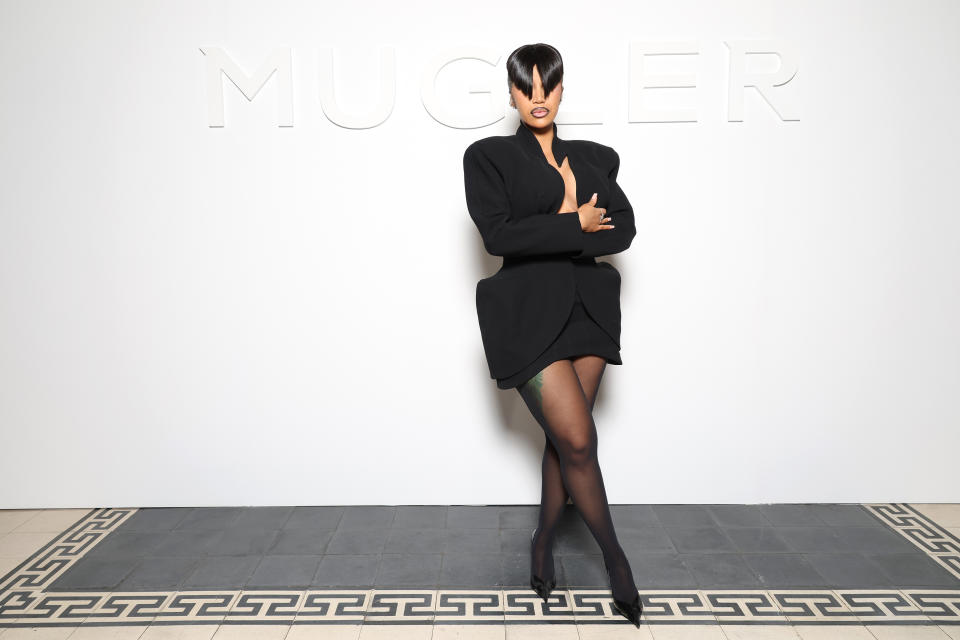 Cardi B poses in a structured blazer dress with matching heels at a Mugler event