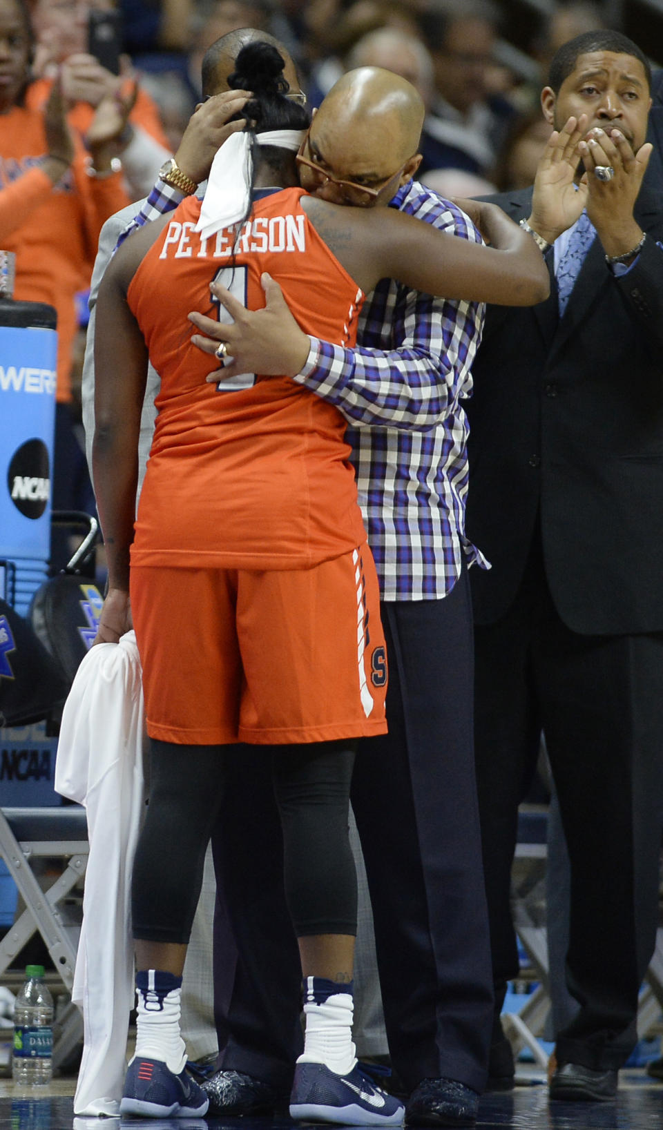 Syracuse coach Quentin Hillsman embraces Alexis Peterson, left, as she comes out of the game during the second half against Connecticut in the second round of the NCAA women's college basketball tournament, Monday, March 20, 2017, in Storrs, Conn. (AP Photo/Jessica Hill)