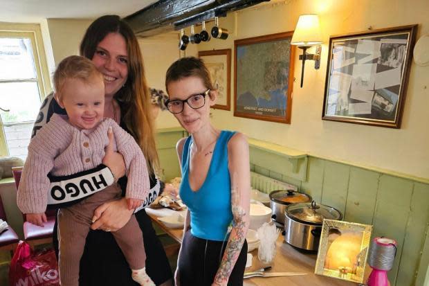Dorset Echo: Sophie Gardiner, owner of Hardy's Hophouse, holding baby Harper and Ollie Isbell
