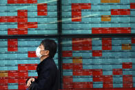 A man walks past an electronic stock board showing Japan's Nikkei 225 index at a securities firm Wednesday, April 8, 2020, in Tokyo. Asian shares were mostly lower after gyrating in early trading amid uncertainty over the coronavirus outbreak. Japan’s Nikkei 225 inched up in Wednesday morning trading, but benchmarks in Australia, South Korea and Chine are lower. (AP Photo/Eugene Hoshiko)