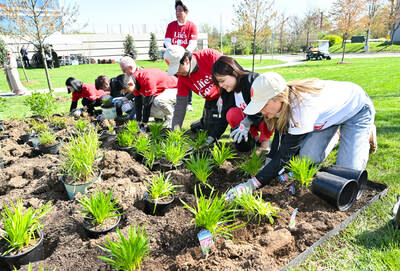 Attendees plant native species at the new pollinator garden at Life's Good Earth Day Community Fair, Monday, April 22, 2024, at the LG Electronics North American Innovation Campus in Englewood Cliffs, NJ.  Earning a Certified Wildlife Habitat® certification through the NWF, LG's garden is outfitted with native plants, designed to attract a mixture of pollinators, such as bees, butterflies, moths, and beetles, which will encourage biodiversity, plant growth, clean air, and support wildlife.  (Diane Bondareff/AP Images for LG Electronics)