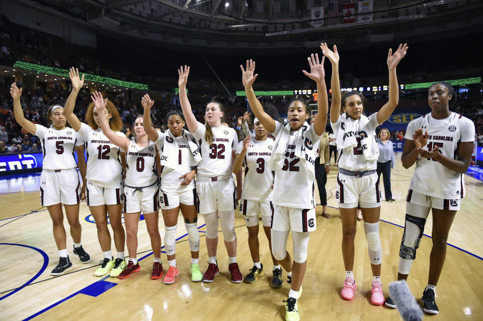 FILE - In this March 6, 2020, file photo, South Carolina players celebrate after defeating Georgia 89-56 in a quarterfinal match at the Southeastern women's NCAA college basketball tournament in Greenville, S.C. Dawn Staley and South Carolina are back in a familiar spot: No. 1 in The Associated Press Top 25 women's basketball poll, released Tuesday, Oct. 19, 2021.(AP Photo/Richard Shiro, File)