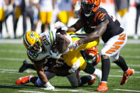 Green Bay Packers running back A.J. Dillon (28) dives for yardage is he is tackled by Cincinnati Bengals linebacker Germaine Pratt (57) in the second half of an NFL football game in Cincinnati, Sunday, Oct. 10, 2021. (AP Photo/AJ Mast)