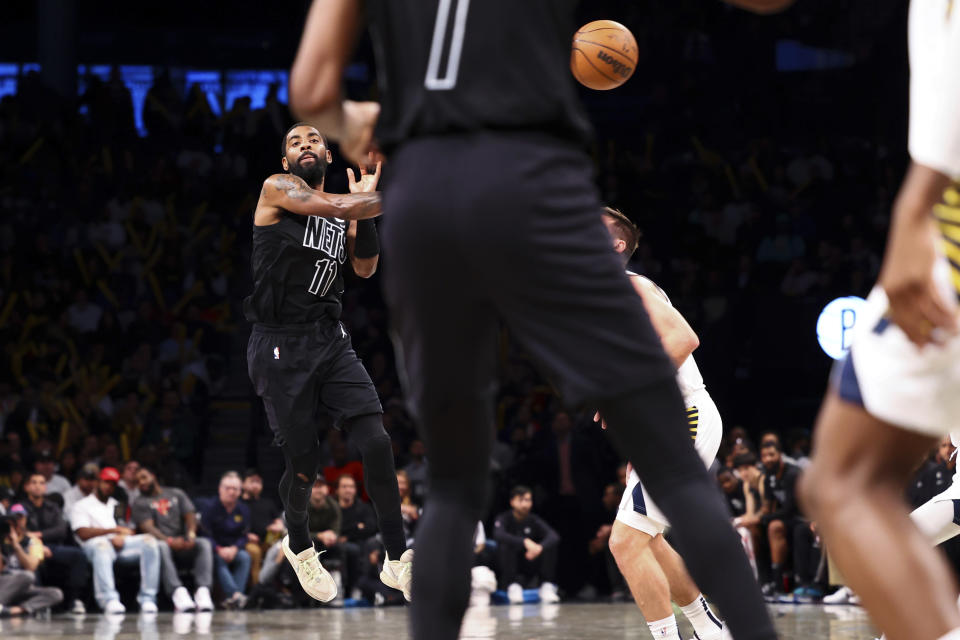 Brooklyn Nets guard Kyrie Irving (11) passes the ball against the Indiana Pacers during the second half of an NBA basketball game Monday, Oct. 31, 2022, in New York. (AP Photo/Jessie Alcheh)