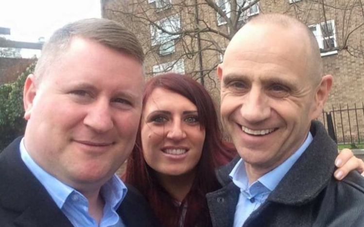 Pictured: Evan Davis standing next to Britain First members