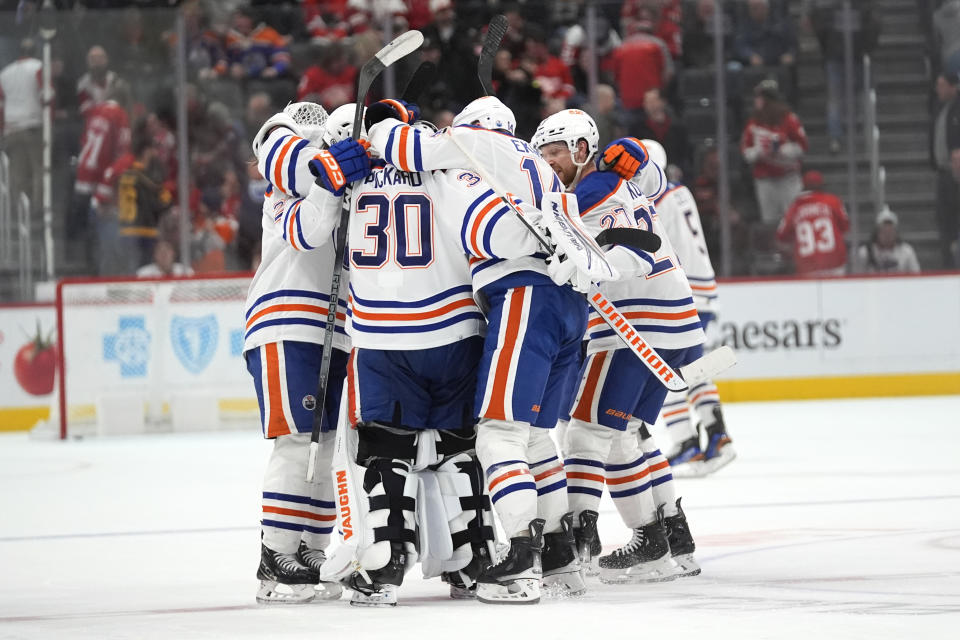 Edmonton Oilers goaltender Calvin Pickard (30) celebrates with teammates after beating the Detroit Red Wings in overtime during an NHL hockey game Thursday, Jan. 11, 2024, in Detroit. (AP Photo/Paul Sancya)